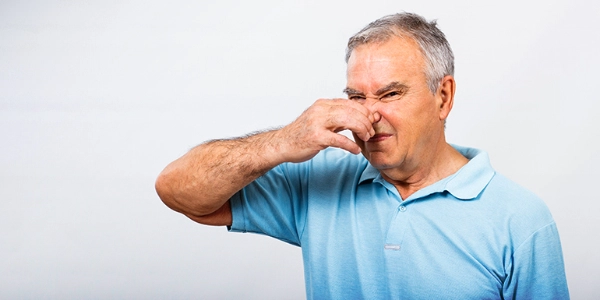 Man holding his nose