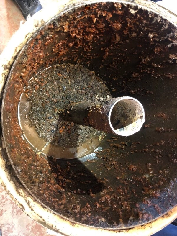 The filthy interior of a failing Poly-B pipe that is being replaced.