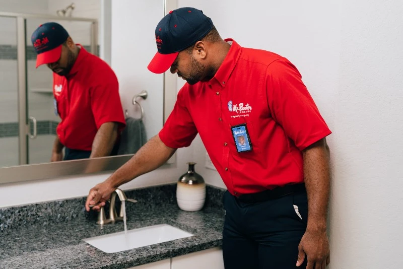 Service professional runs water in sink after drain cleaning