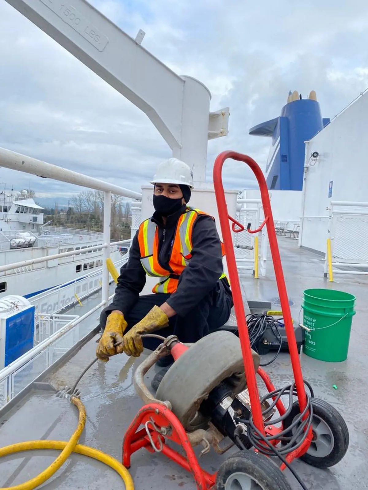 Mr. Rooter Plumbing professional clearing clogged drain on boat in Vancouver