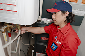 Mr. Rooter technician fixing a water heater.