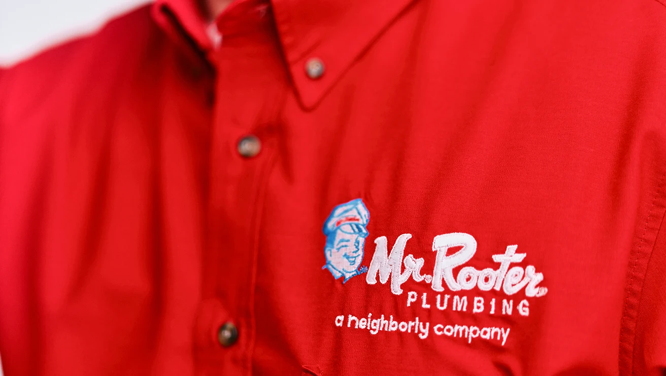 Close up view of a red Mr. Rooter work shirt.