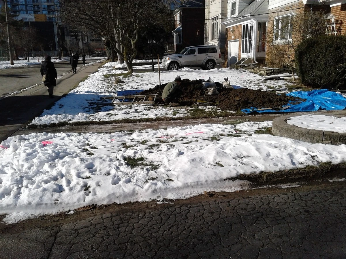 Mr. Rooter Plumbing expert performing North York sewer line replacement in front lawn