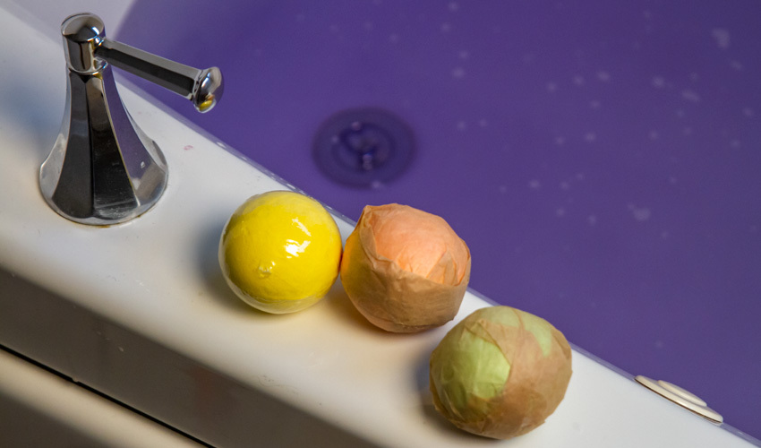 Bath bombs on a bathtub ledge