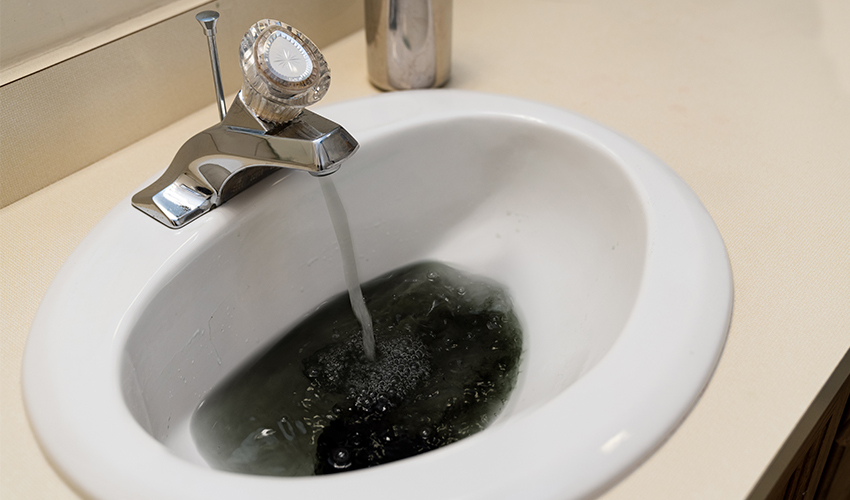 Sink Faucet with black water pouring out