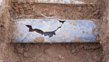 Collapsed pipe in Markham sitting in a hole below a residential yard.