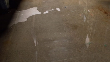 Wet floors in a residential basement that is being affected by serious, widespread flooding from a slab leak.