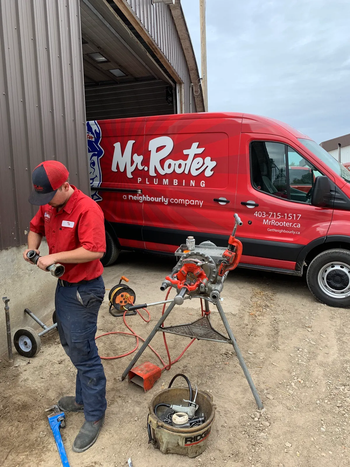 A plumber from Mr. Rooter Plumbing using specialized equipment to complete commercial pipe repairs for a commercial warehouse property.