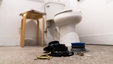 Flange parts on the floor in front of a toilet