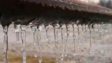 Icicles hanging from a pipe