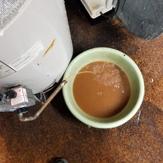 Draining a water heater at a customers home in Edmonton