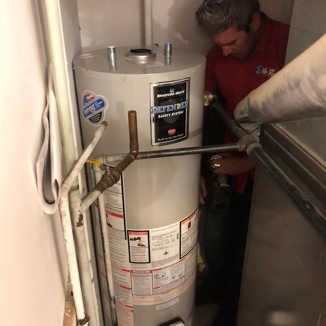 Water heater installation in a tight spot at a customers home in Edmonton