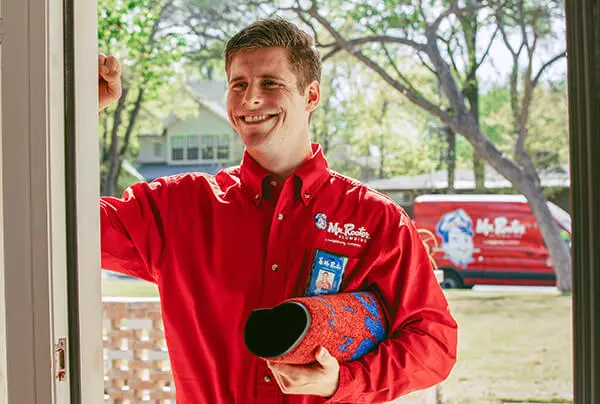 Mr. Rooter employee knocking on a customer's door.