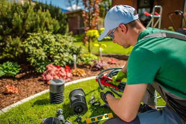 An irrigation specialist adjusting hoses for an irrigation system installation. 